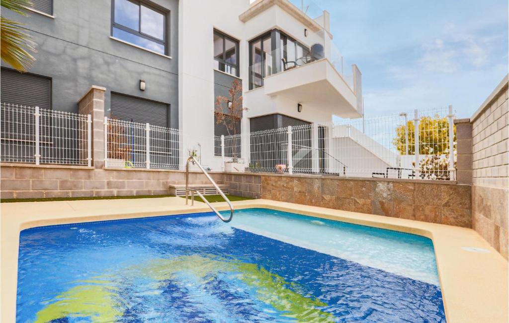 een zwembad voor een huis bij Nice Apartment In Pilar De La Horadada With Jacuzzi in Pilar de la Horadada
