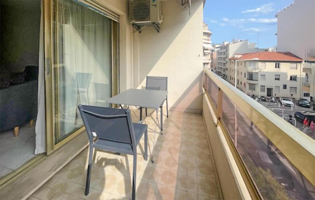 un balcon avec deux chaises et une table sur un immeuble dans l'établissement 1 Bedroom Awesome Apartment In Cannes, à Cannes