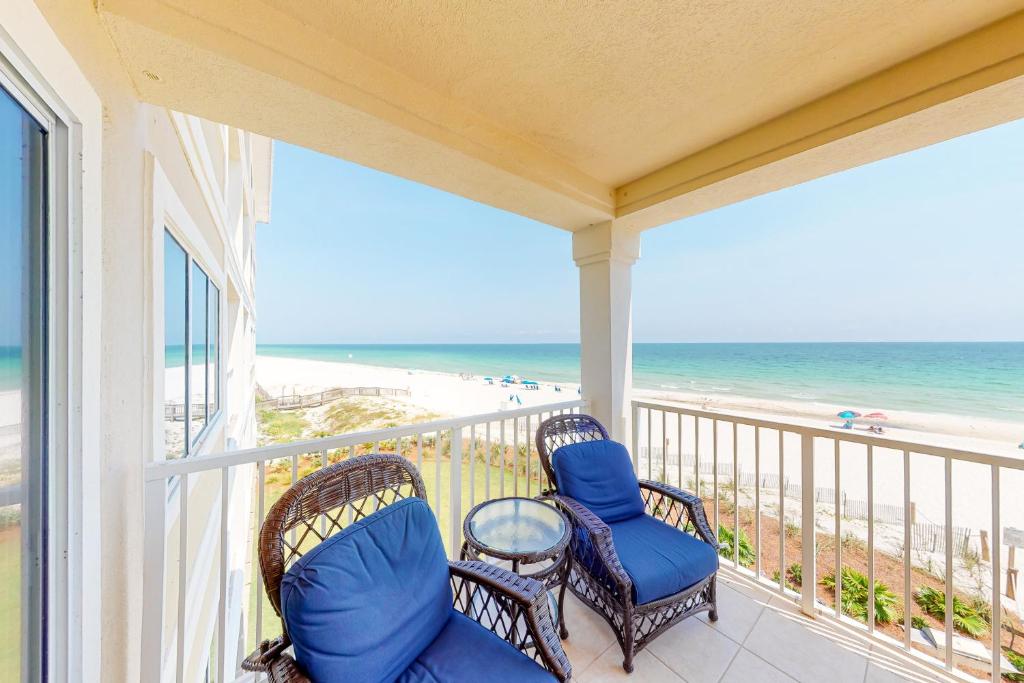 a balcony with chairs and a view of the beach at Marlin Key 2D in Orange Beach