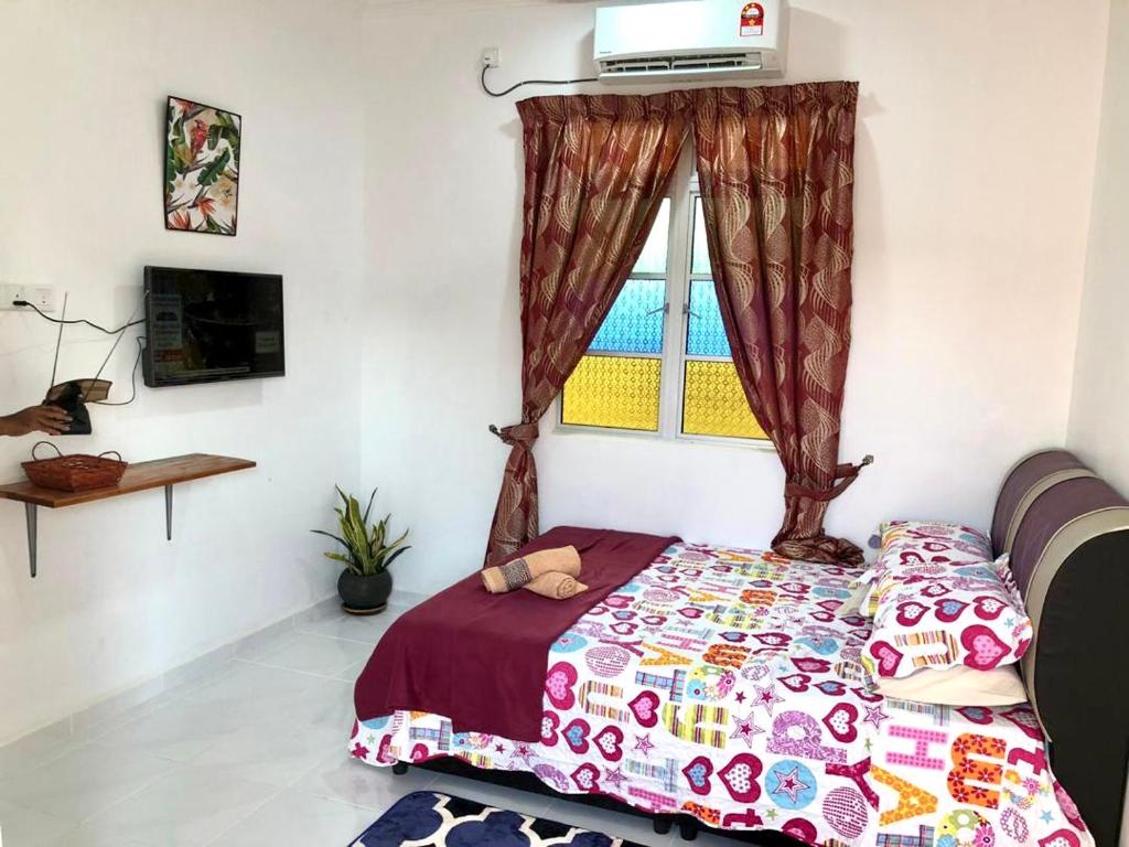 Postel nebo postele na pokoji v ubytování Lakse Inn Homestay