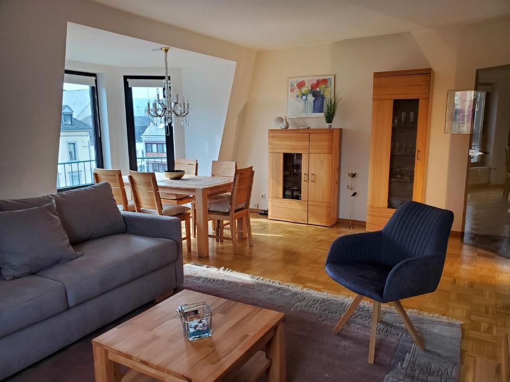 a living room with a couch and a table at Komfort FeWo Stadt Mitte in Trier