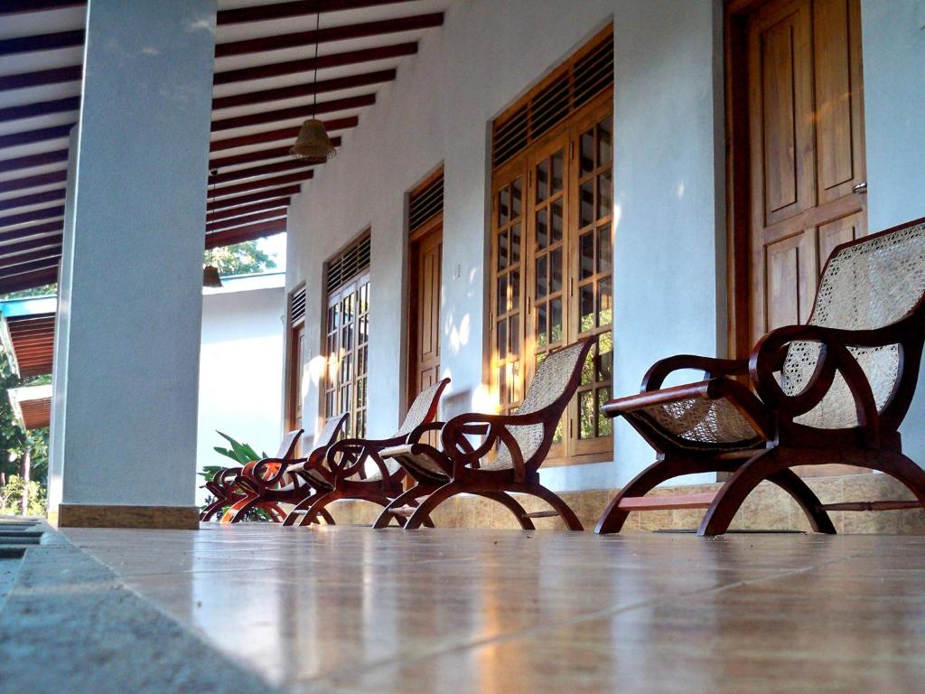 a row of chairs sitting outside of a building at Le Grand Meaulnes in Habarana