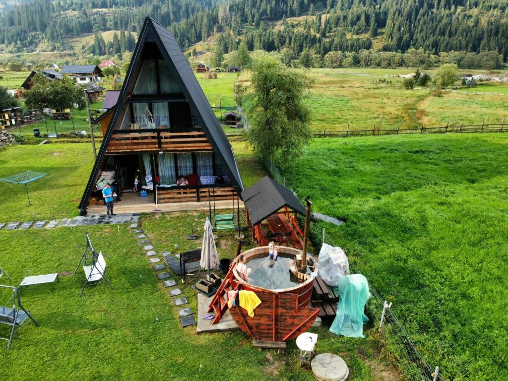 an overhead view of a small house with a tub at Cabana Alpin in Vatra Dornei