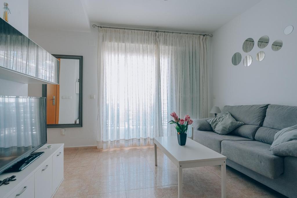 a living room with a couch and a table at Vivienda Turística Sunbeach-Xilxes VT-42192-CS in Xilxes