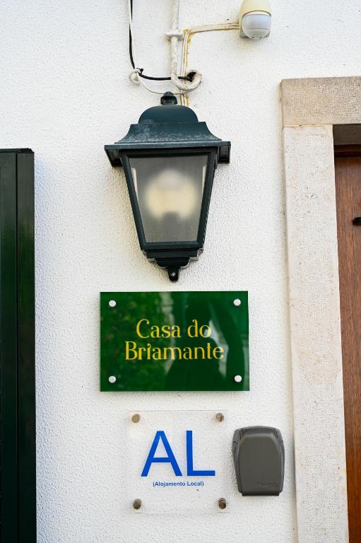 a sign on the side of a building with a street light at Casa do Briamante 9 in Sintra