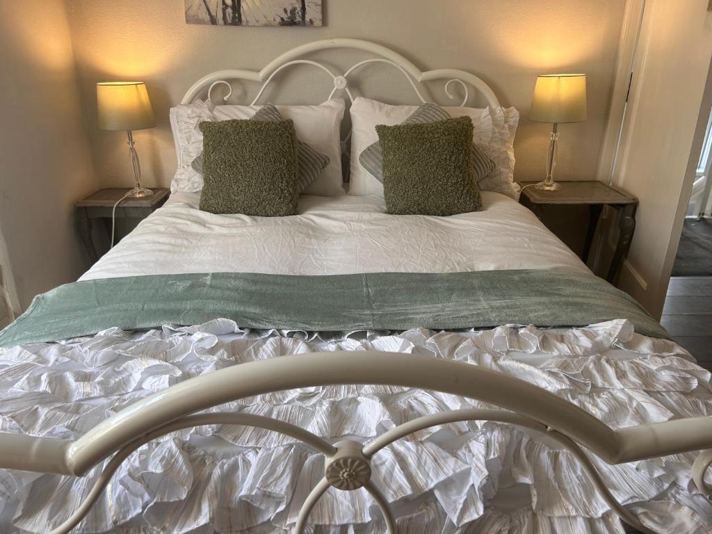 a bed with white sheets and pillows in a bedroom at A Home from Home in Redditch near town centre in Redditch