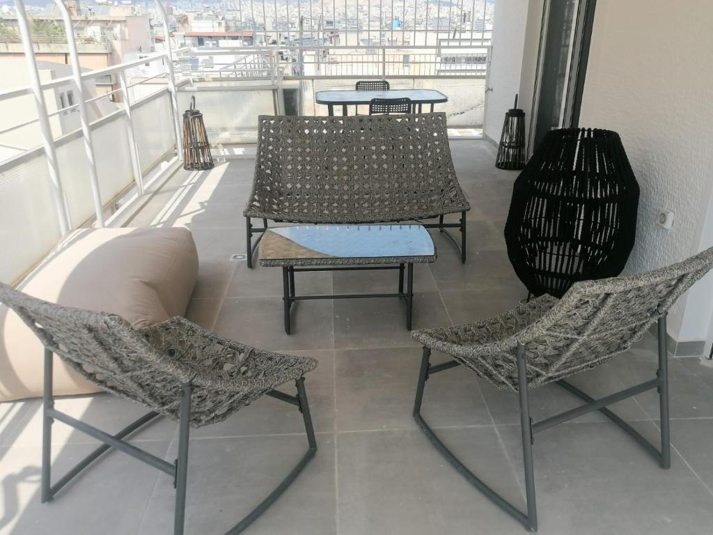a balcony with two chairs and a table on a balcony at New house in Pireas port in Piraeus