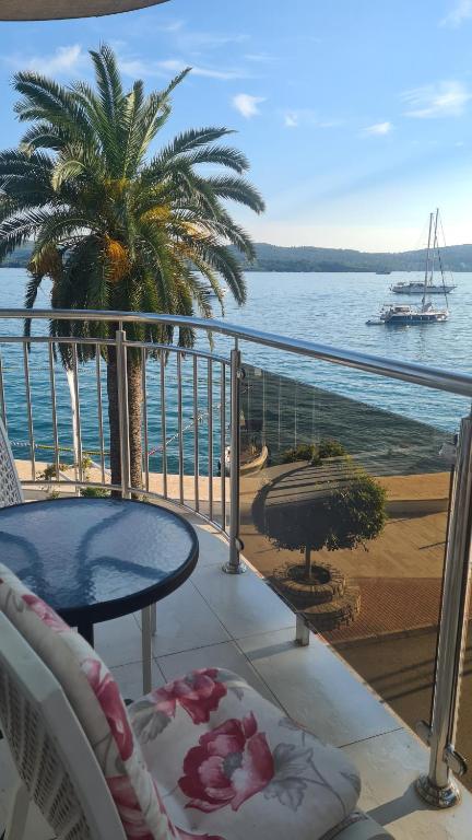 a balcony with a table and a view of the ocean at Chic apartment in the City Center by the sea in Tivat