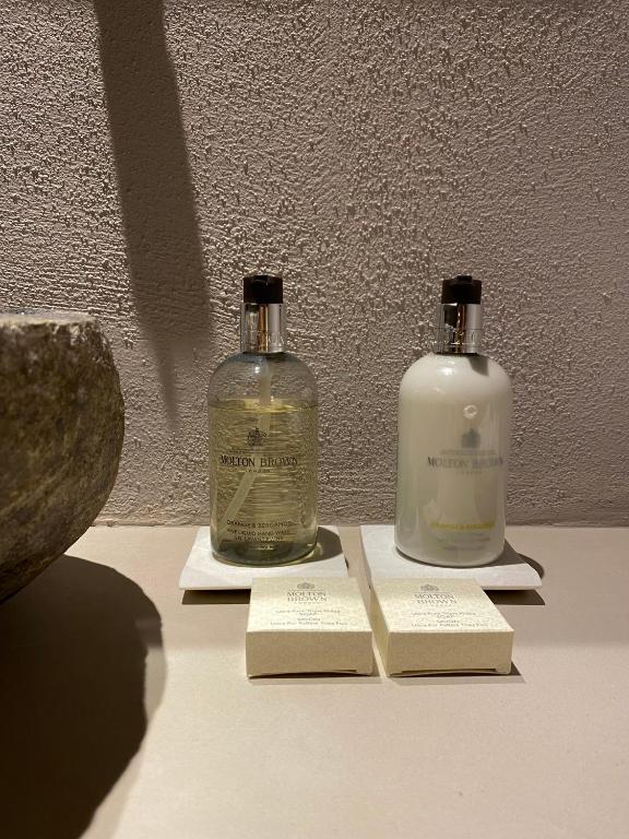 two bottles of soap sitting on top of a table at EJ Boutique Suites in Milina