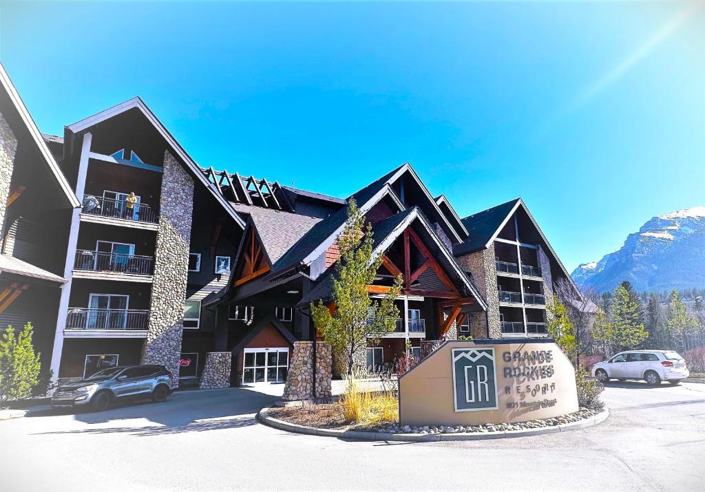 a large building with a sign in front of it at Luxury Two Queen Beds Condo - Grande Rockies Resort Indoor Parking Pool Hot tub GYM in Canmore