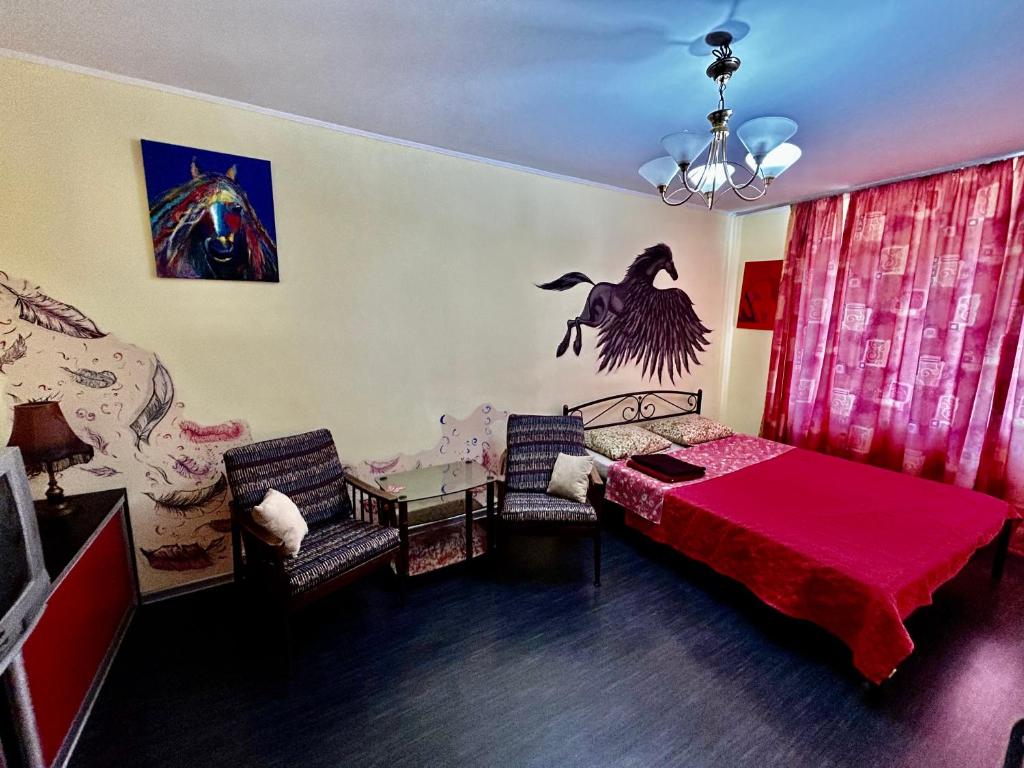 a bedroom with a bed and a table with chairs at Apartment near train station and close to city center in Kyiv