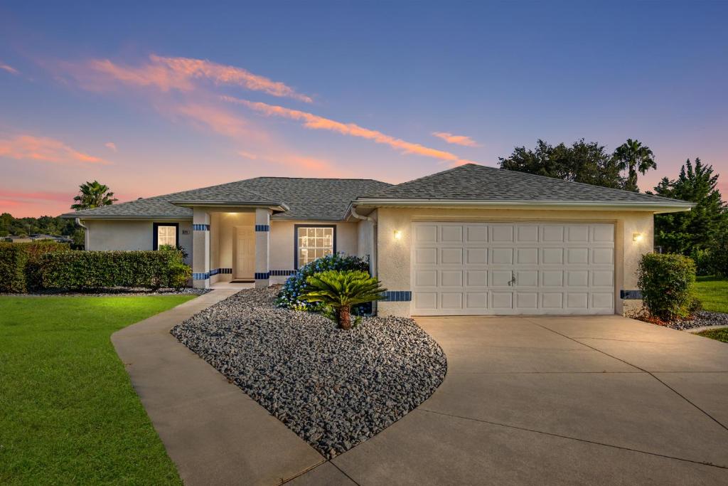 a house with a driveway and a garage at Triple En-Suite Pool Retreat - All Master Bedrooms in Inverness