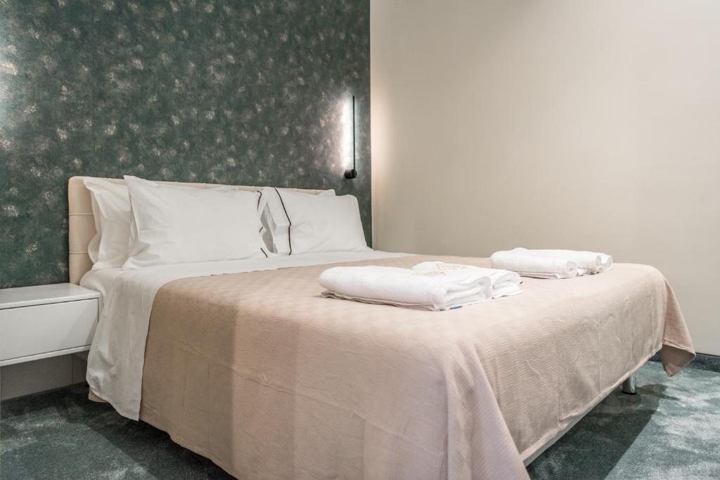 a bedroom with a bed with two towels on it at Piazza Luxury Apartments in Tirana