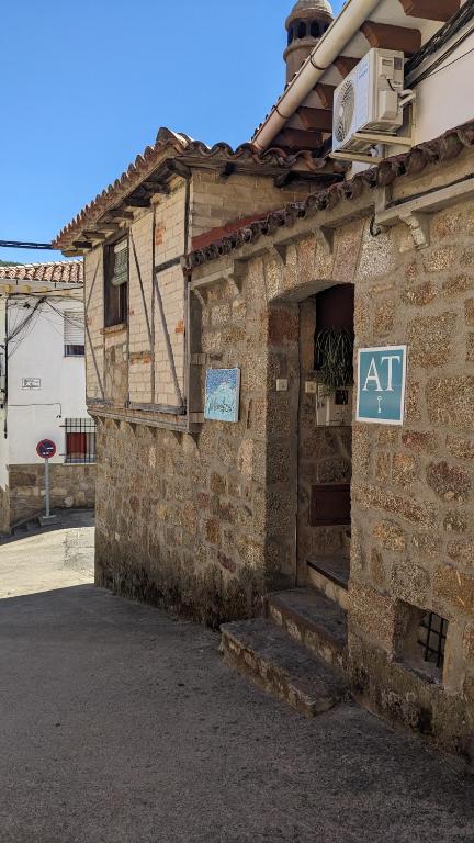 a brick building with an at sign on it at Apartamento Turístico Monteceli AT-CC-00748 in Gata