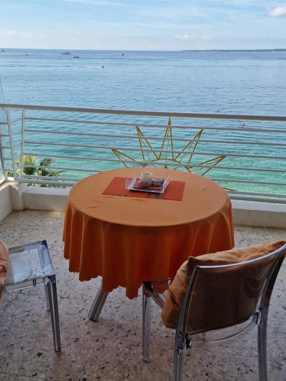 a table and chairs with a view of the ocean at Soleil 2023 in Antibes