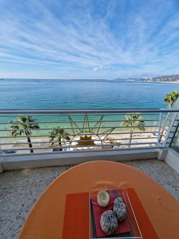 a table with donuts on a balcony with a view of the ocean at Soleil 2023 in Antibes