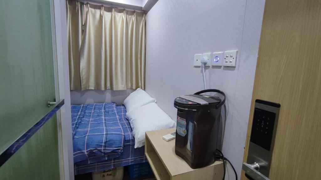 a small room with a bed and a television at M18 Station 103,107 in Hong Kong
