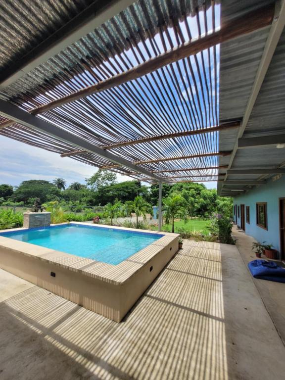 a large swimming pool with a pergola at The Inn at Punta Mala in Pedasí Town
