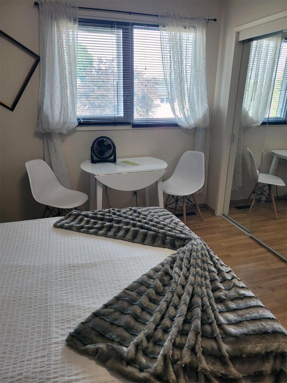 a bedroom with a bed and a table and chairs at The Dewberry Homestay B&B in Edmonton
