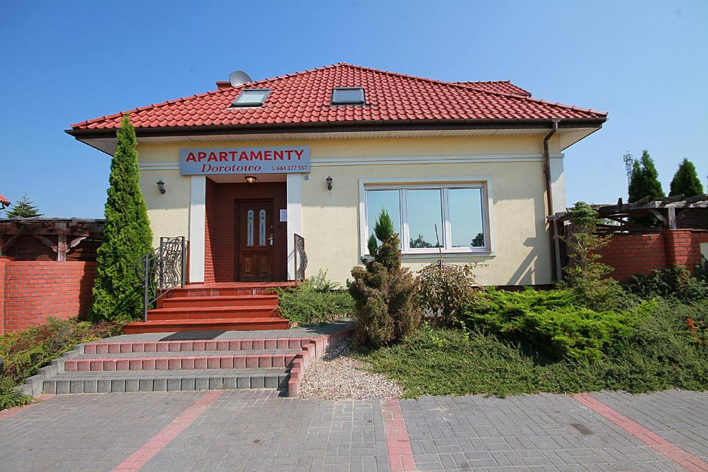 a building with a sign on the front of it at Apartamenty Dorotowo in Dorotowo