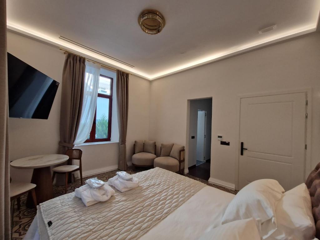 a hotel room with a bed with towels on it at Jensen Luxury Suites in Rhodes Town