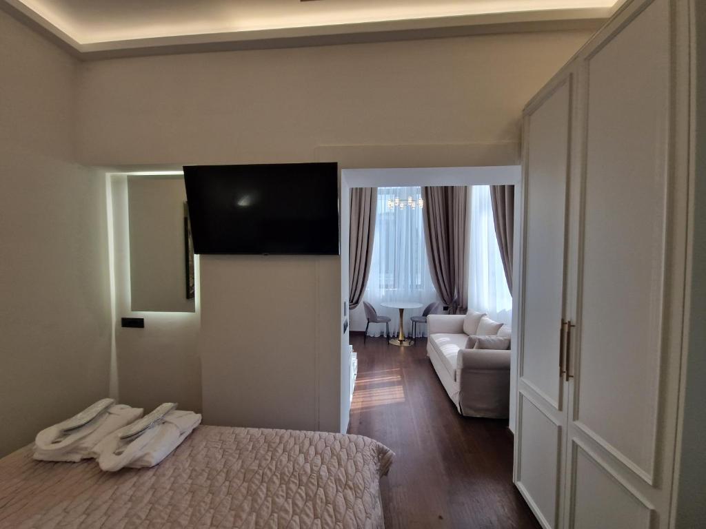 a bedroom with a bed and a living room at Jensen Luxury Suites in Rhodes Town