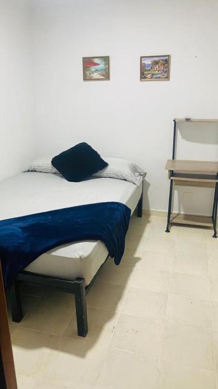 Postel nebo postele na pokoji v ubytování Hostal Cigarra