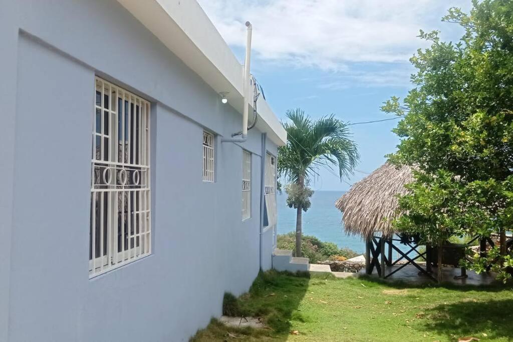 a white house with a view of the ocean at Villa Amanda in Santa Cruz de Barahona