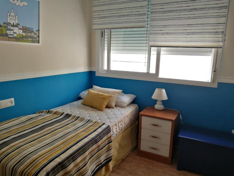 um pequeno quarto com uma cama e uma janela em Fantástico apartamento con vistas en Almerimar em Almerimar