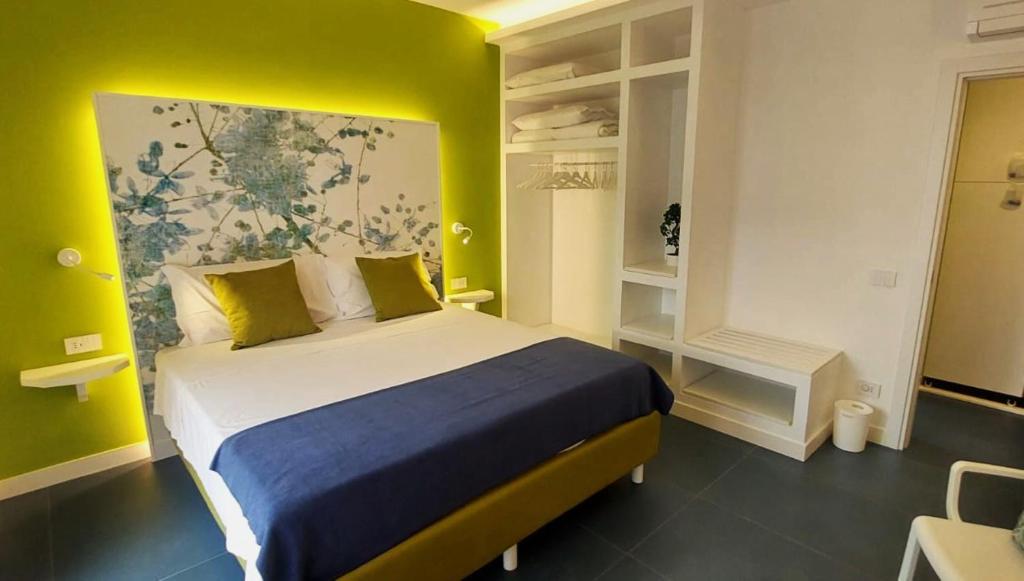 um quarto com uma cama grande e uma parede amarela em CASA Eduardo e Titina em Sorrento