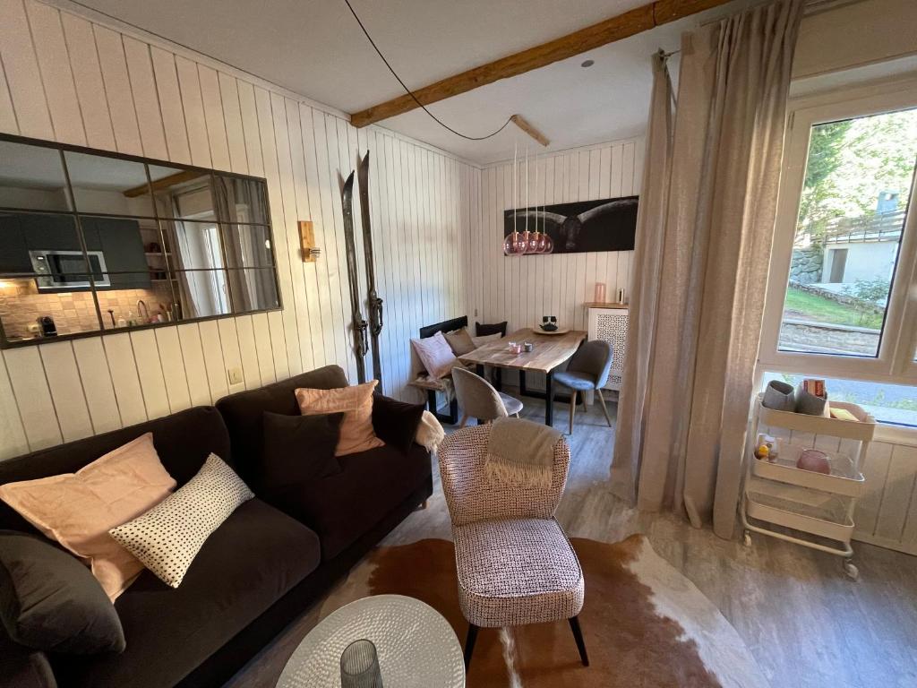 a living room with a couch and a table at Appartamento Kern-Sciare A Portata Di Mano- in Madesimo