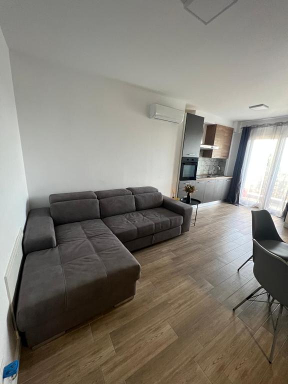 uma sala de estar com um sofá castanho e uma mesa em Feeling Home 2 em Oradea