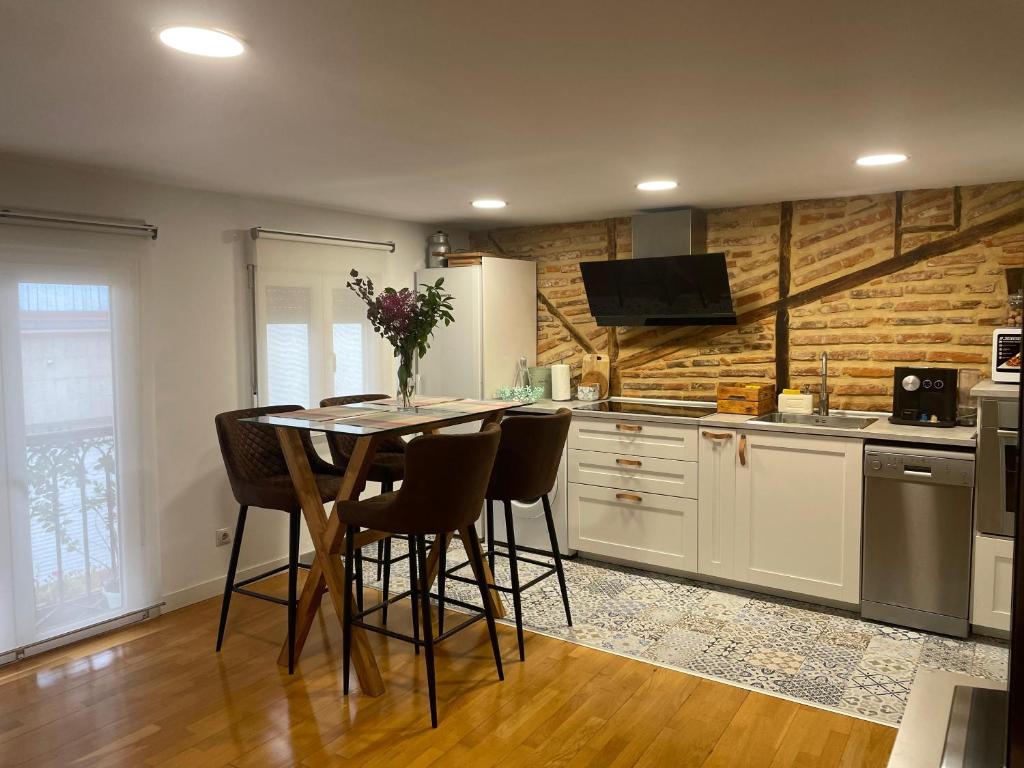 a kitchen with a table and chairs in a room at Bertoko Urdaibai III in Bermeo