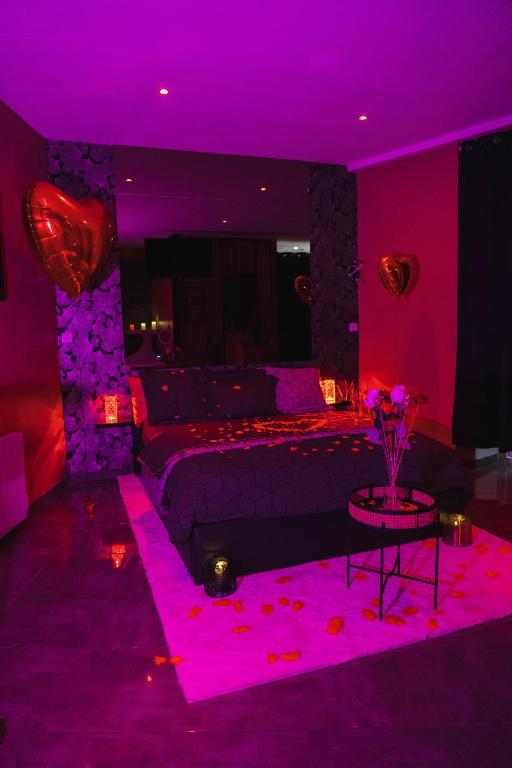 a bedroom with a bed and a purple ceiling at HomeSparadise Loveroom in Besançon