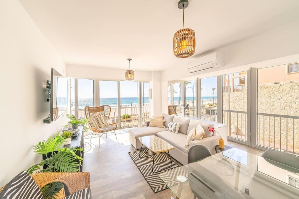a living room with a couch and a view of the ocean at Costa Blanca Holiday Rental La Cenia I in El Campello