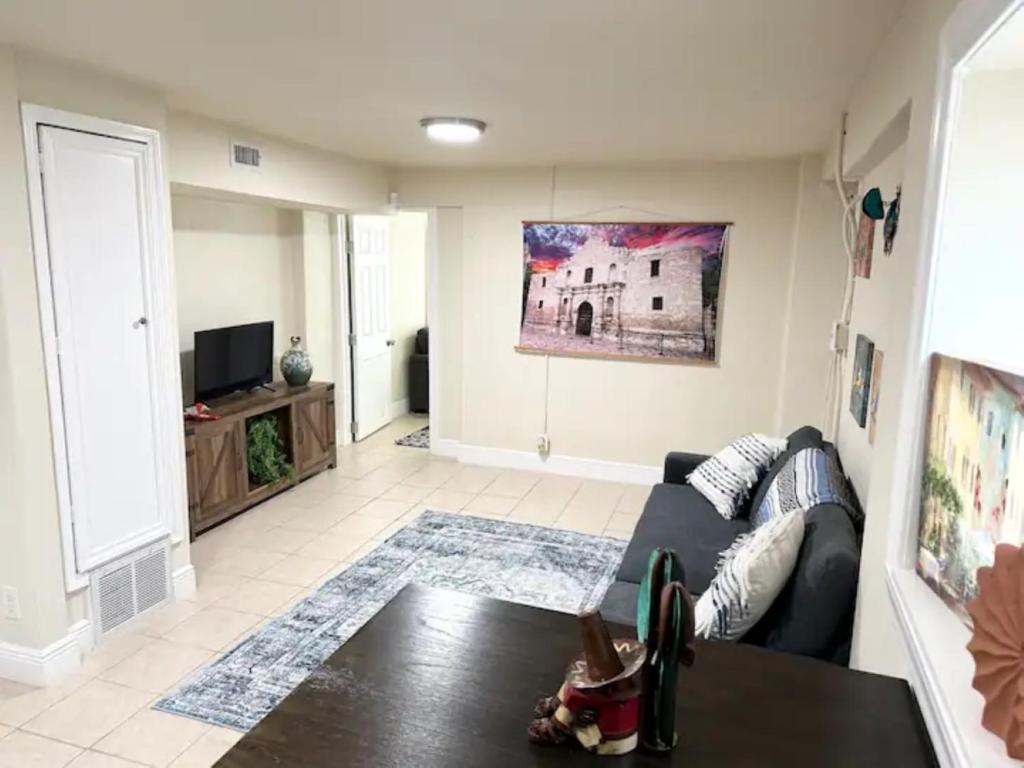 a living room with a couch and a table at Minutes to the River Walk and the Alamo Pet Friendly Sleeps 8! in San Antonio
