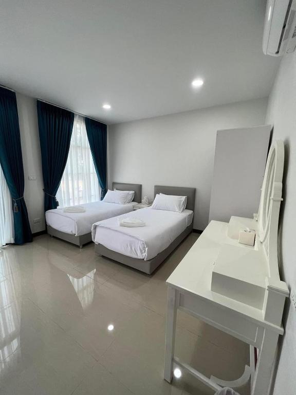 Postel nebo postele na pokoji v ubytování คีรีศิลป์ รีสอร์ท เชียงราย (Khirisin Resort Chiang rai)