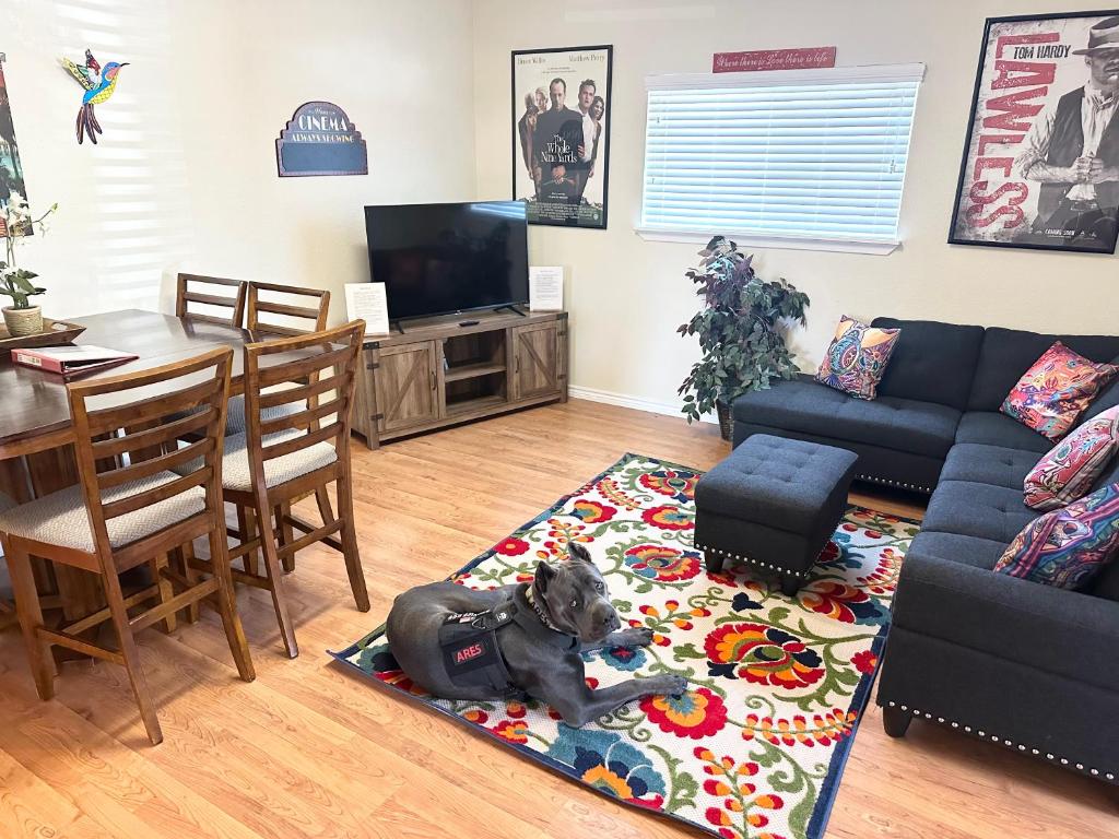 a dog laying on a rug in a living room at Minutes to Riverwalk, Sleeps 12, Pets Welcome! in San Antonio
