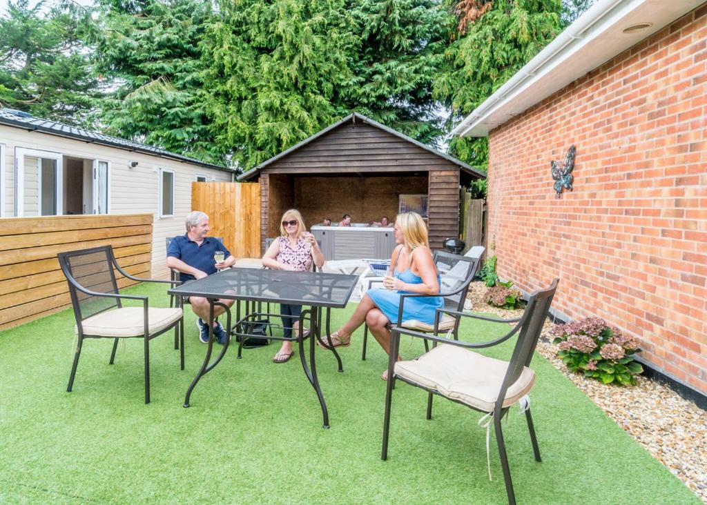 a group of people sitting at a table in a backyard at Stunning Home In Axminster W- in Axminster