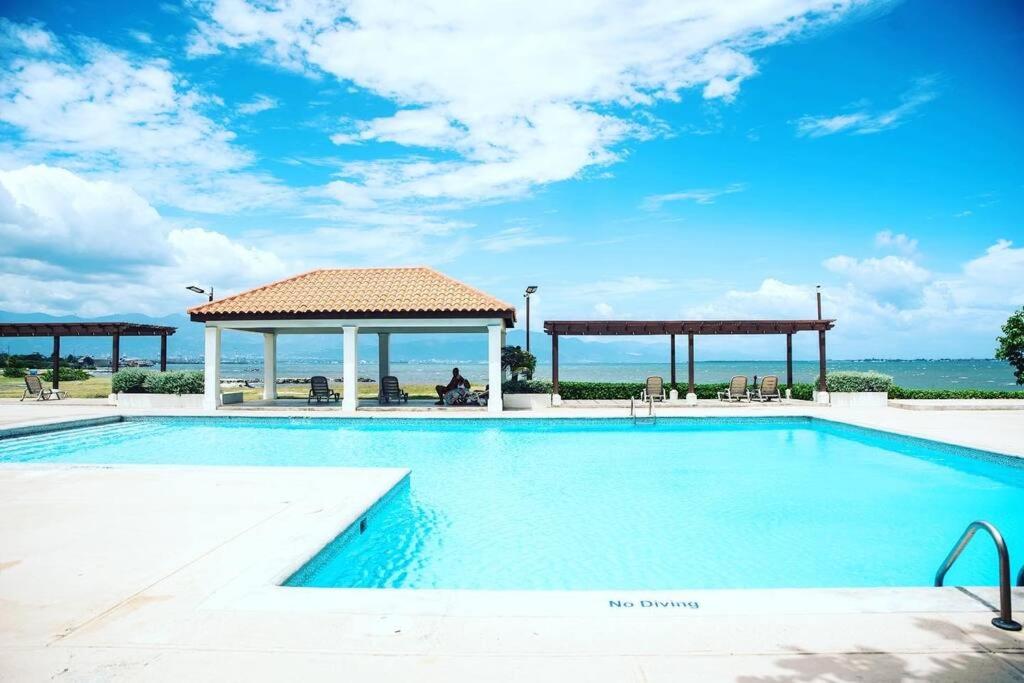 a large swimming pool with a gazebo at Breathtaking Oceanfront in Portmore