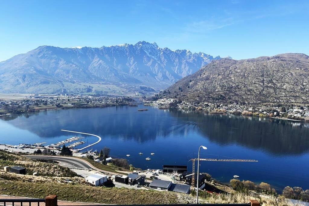 a view of a large body of water with mountains at Views on Florence in Queenstown