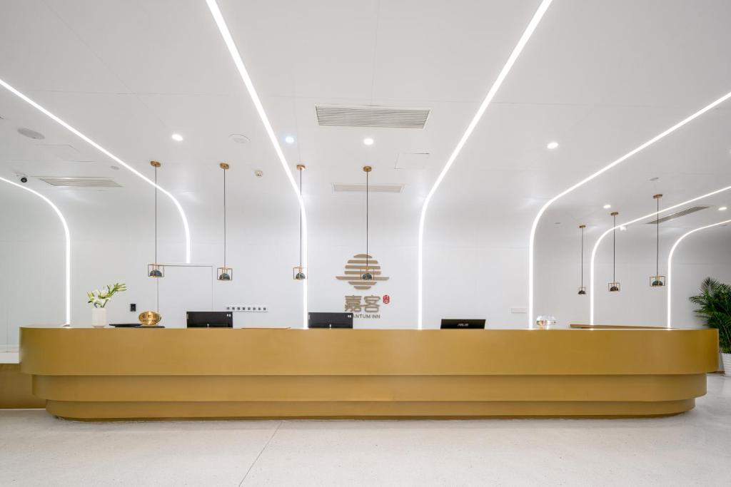 a large lobby with a reception desk in a building at Quantum Inn - Hangzhou East Railway Station in Hangzhou