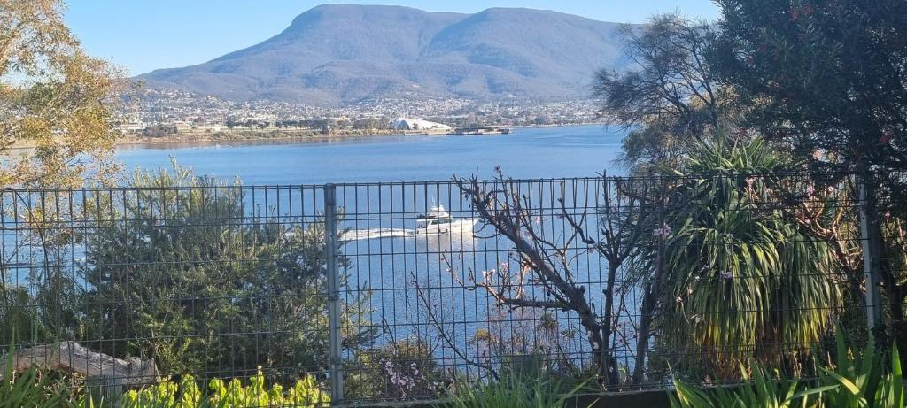 a view of a lake with a boat in the water at Waterfront Abode - 2 bedrooms in Hobart