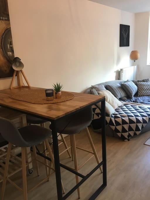 a living room with a table and a couch at Appartement Lille Europe in Lille