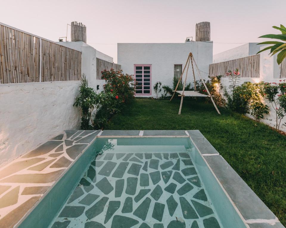 a backyard with a swing in the grass at The Luxe Pushkar By Namli Hotels in Pushkar