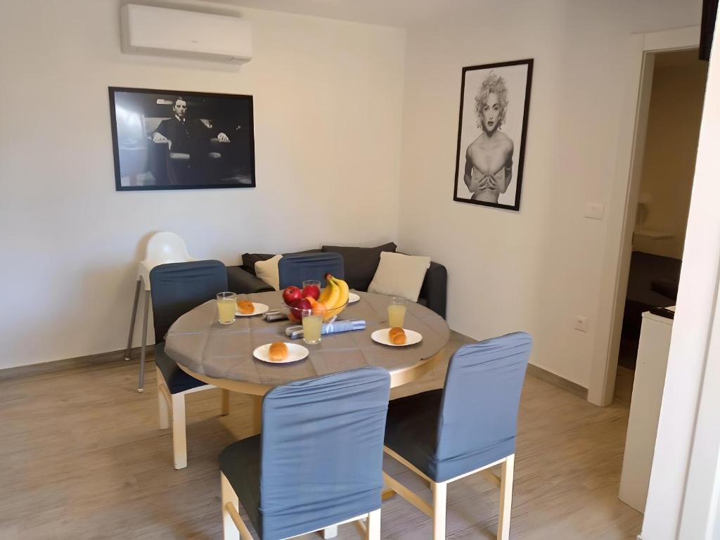 a dining room with a table and blue chairs at Apartment Patrik in Vabriga