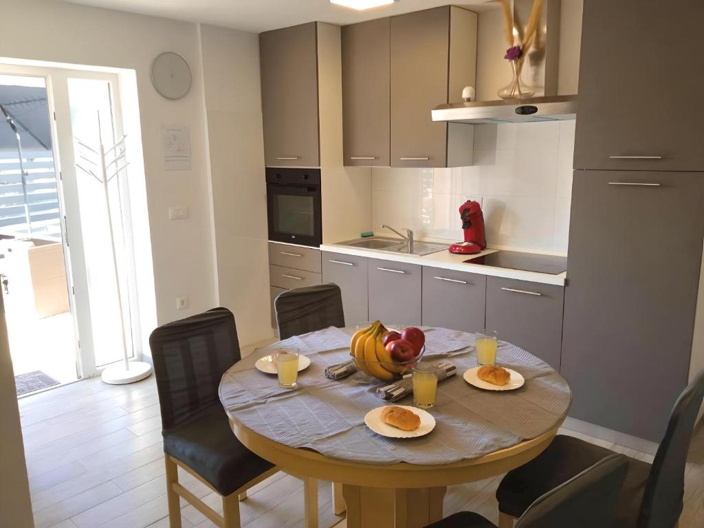 a kitchen with a table with plates of food on it at Apartment Patrik in Vabriga