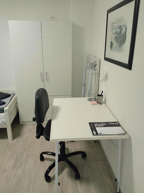 a white desk and a chair in a room at Apartment Patrik in Vabriga