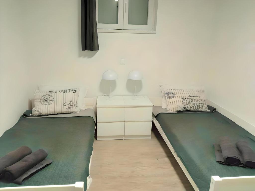 two beds sitting next to each other in a room at Apartment Patrik in Vabriga
