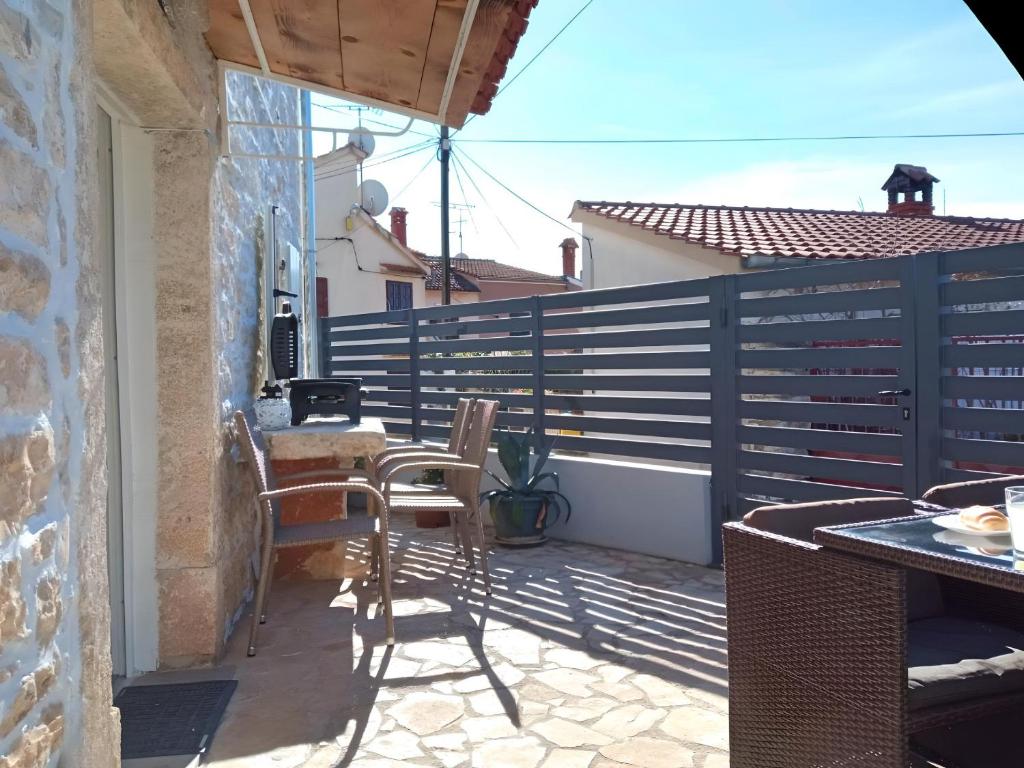 a balcony with a table and chairs on a patio at Apartment Patrik in Vabriga